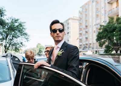 Groom near the car, documentary wedding photography