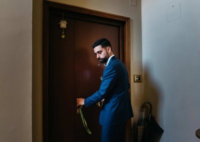 Groom exiting from home in documentary wedding photography style