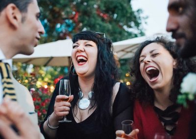 Invited guests laugh during a wedding in Italy