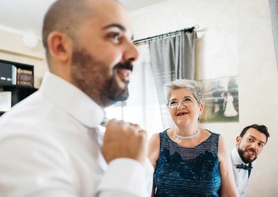 Groom preparation with his mother and best man, picture shot in documentary wedding photography style